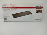 Plaque de cuisson en fonte Grandhall dans sa boîte d'emballage.